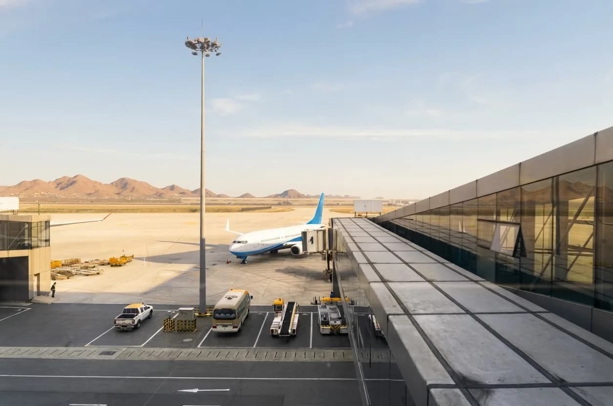 Desert mountains beyond an aircraft at the jet bridge at Phoenix Sky Harbor