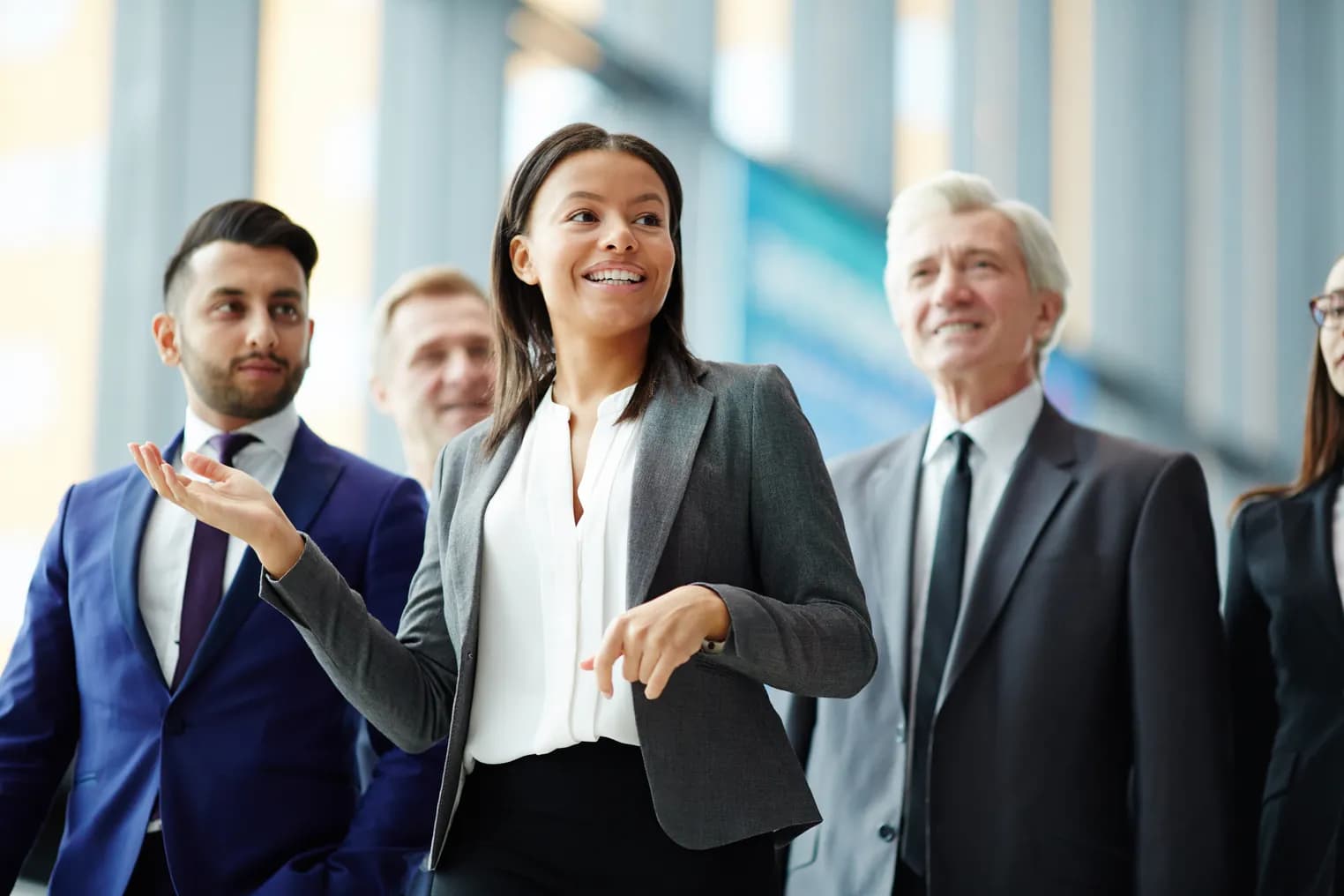 A corporate travel team talking in an airport concourse