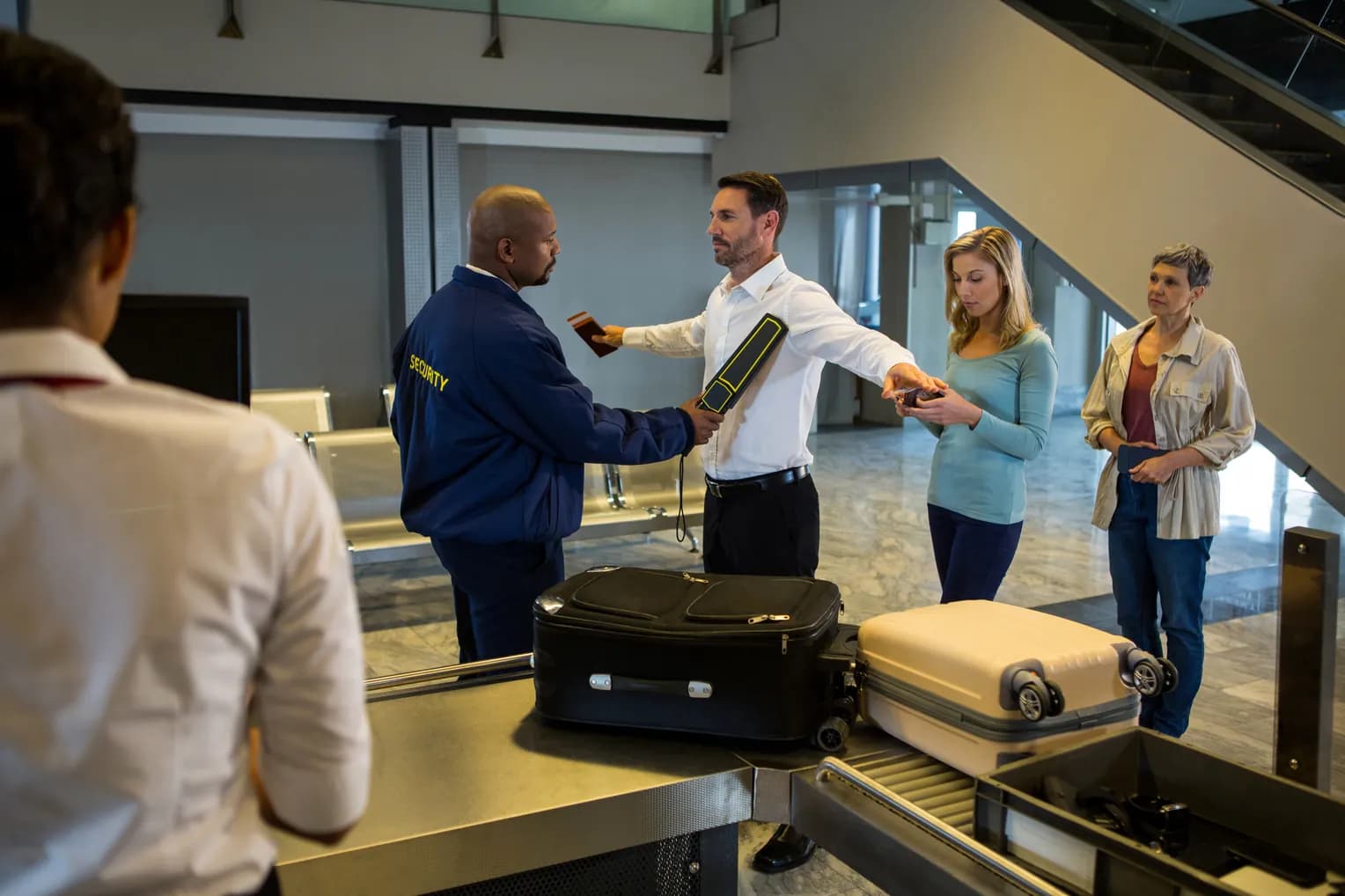 A traveler being screened at an airport security checkpoint