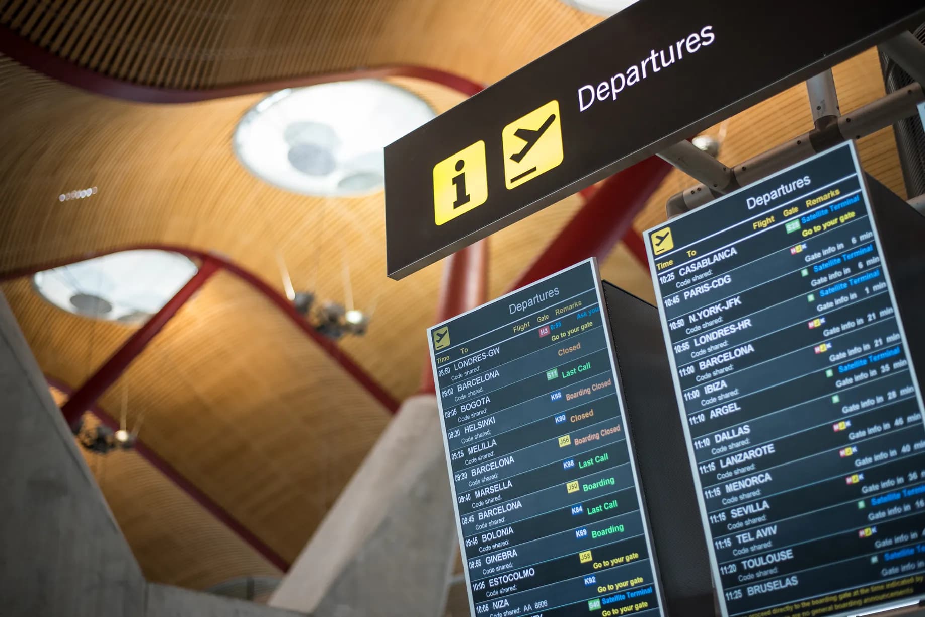 Departure boards above an airport concourse