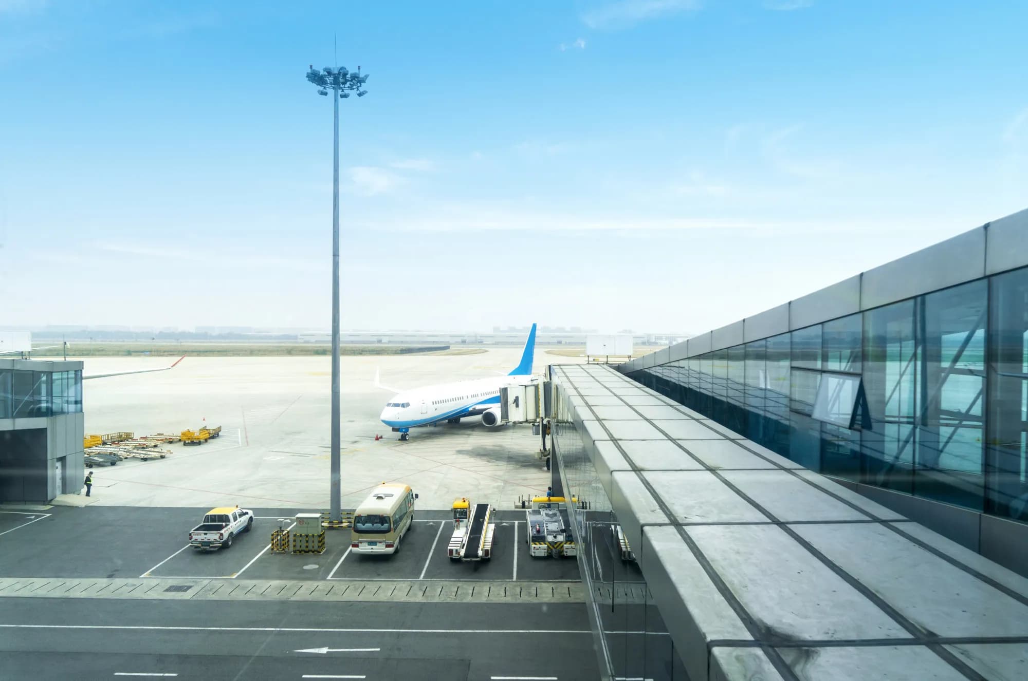 An aircraft at the jet bridge, seen from an airport terminal window