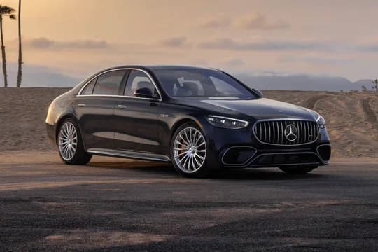A luxury sedan parked outside an arrivals terminal