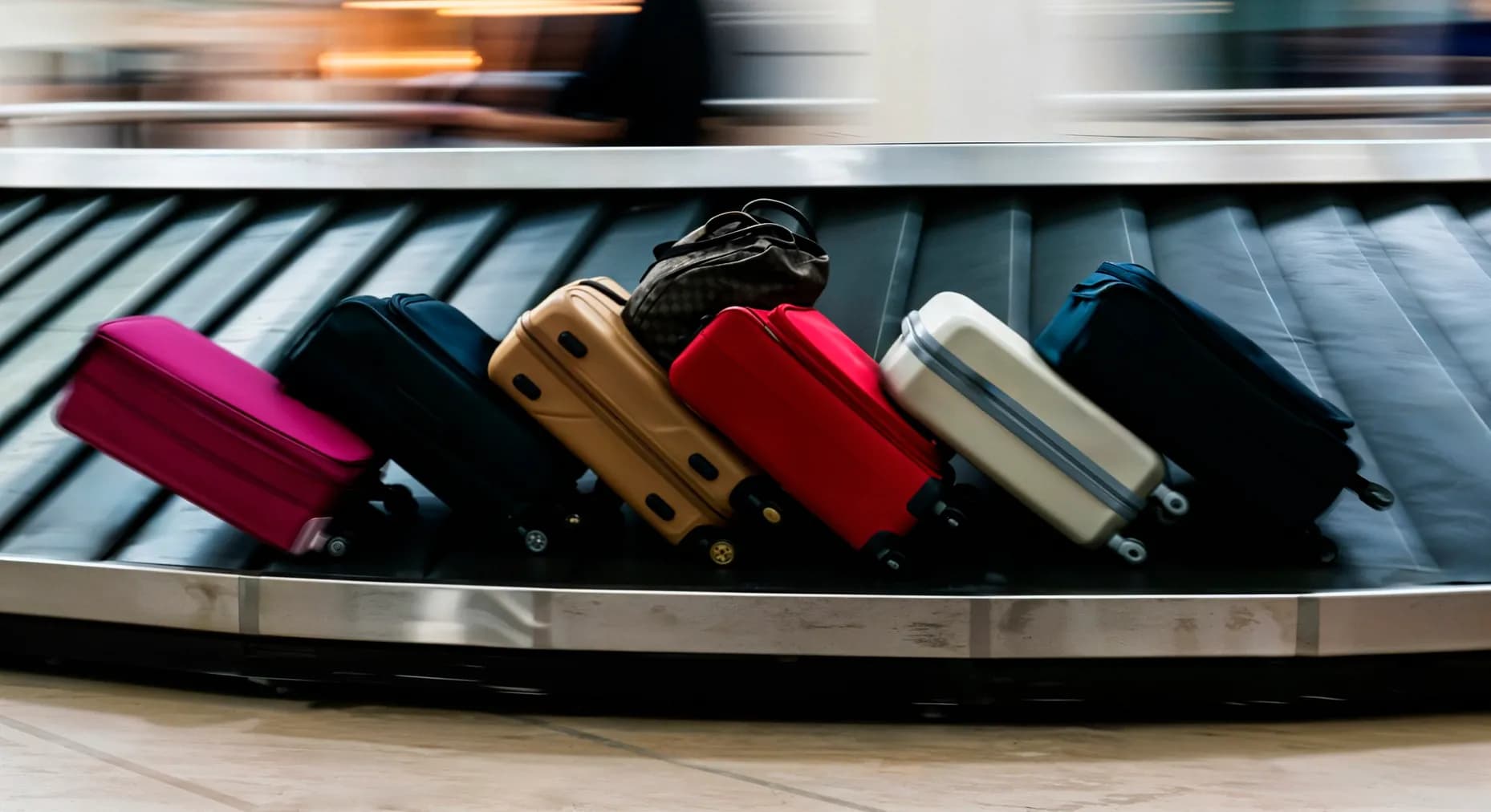 Suitcases riding a baggage reclaim carousel